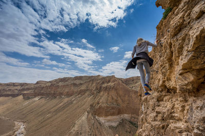 Full length of woman standing on rock