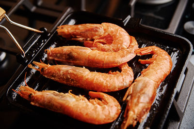 Grilled large shrimps with lemon and spices on grill pan
