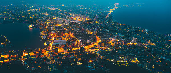 High angle view of illuminated buildings in city at night