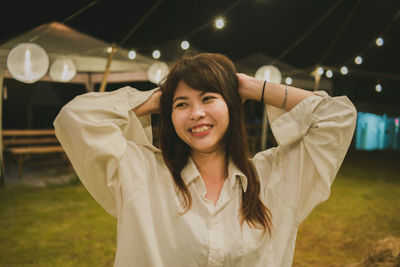 Portrait of smiling young woman standing outdoors