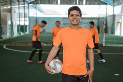 Portrait of man playing soccer at park