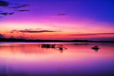 Scenic view of lake against romantic sky at sunset