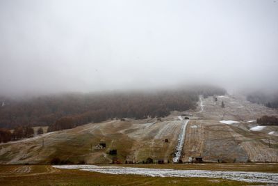 Aerial view of landscape against sky during winter