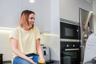 Women talking while in kitchen at home