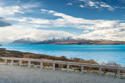 Mount cook road alongside lake pukaki with snow capped southern alps in winter evening light. 