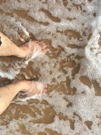 High angle view of people relaxing on sand at beach