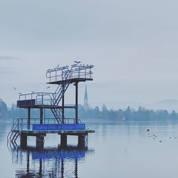 Lifeguard hut in sea against sky