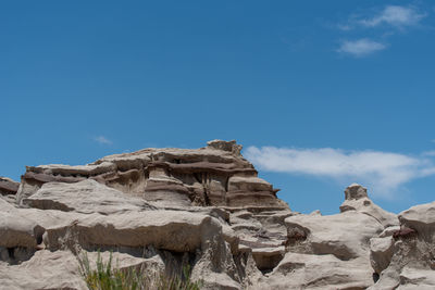 Low angle view of rock formation against blue sky