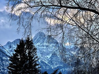 Low angle view of snowcapped mountain against sky