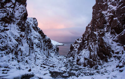 Scenic view of snow covered mountains against sky during sunset