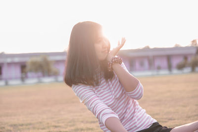 Portrait of beautiful woman against clear sky