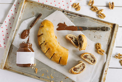 Roll with chocolate paste filling and walnuts. homemade sweet pastries.