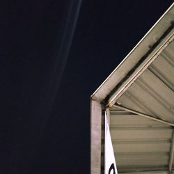 Low angle view of building against clear sky at night