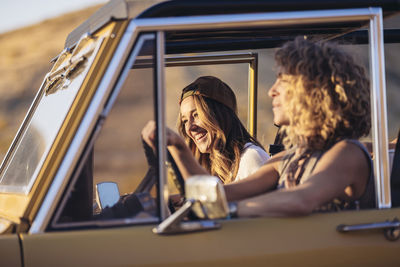 Happy female friends in off-road vehicle