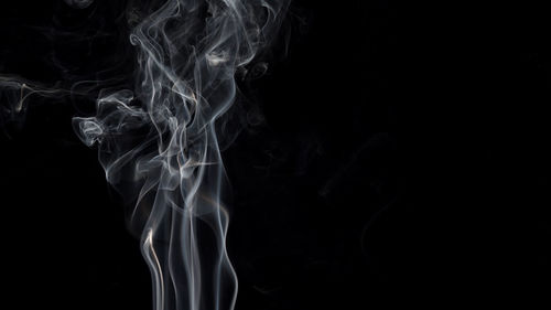 Close-up of smoke against black background