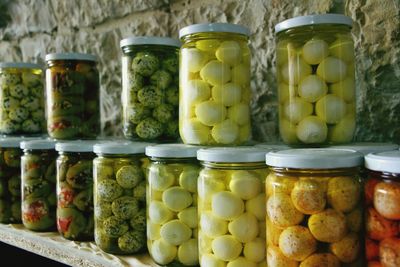 Various pickles in jar on shelf for sale at store