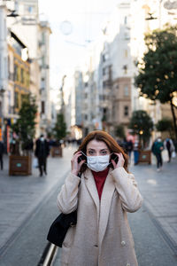 Portrait of woman standing on city street