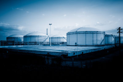 Factory against sky at dusk