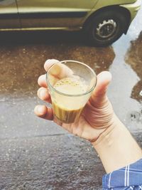 Close-up of hand holding coffee cup