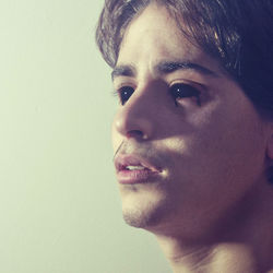 Close-up portrait of young man against wall