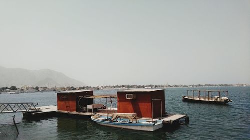 Boat moored near floating platform on sea