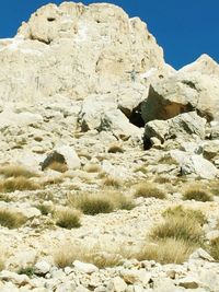 Low angle view of rocks against clear sky