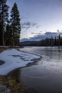 Scenic view of frozen lake against sky during winter