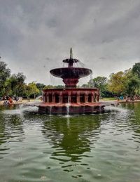 View of fountain in lake against sky