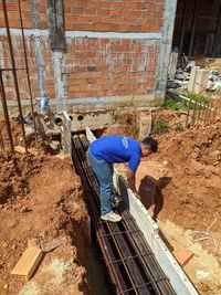 High angle view of man working on wall