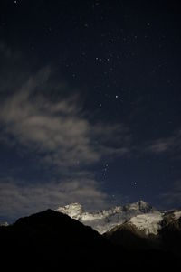 Low angle view of mountain against sky at night