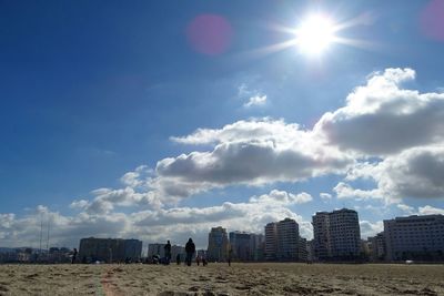 Buildings in city against cloudy sky