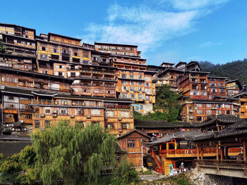 Buildings in town against sky