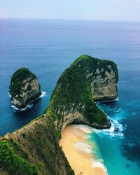 High angle view of rock formation in sea against sky