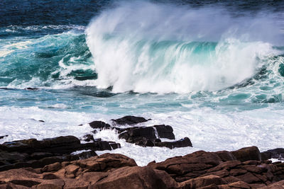 Waves splashing on rocks at shore