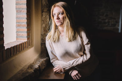 Portrait of young woman sitting outdoors