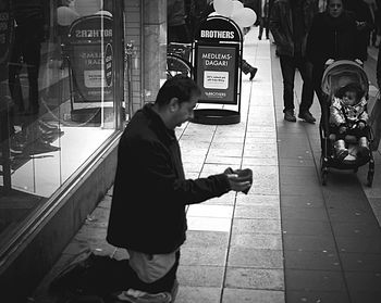 Full length of man standing on footpath