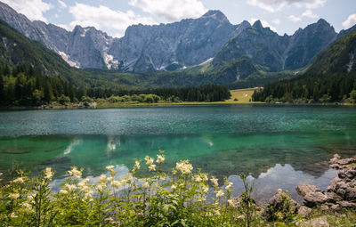 Scenic view of lake and mountains against sky