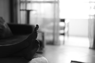 Low angle shot of woman's feet on otoman at home