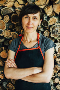 Female carpenter in apron looking at camera, close up portrait