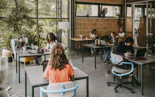 Female and male colleagues working at coworking office