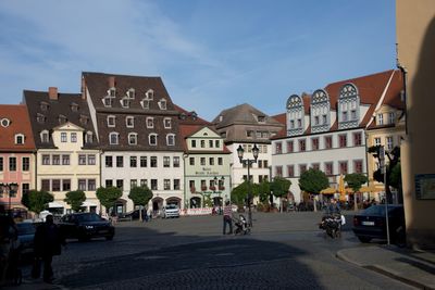 View of city street and buildings against sky