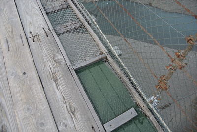 High angle view of abandoned metal fence on footpath