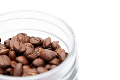 Close-up of roasted coffee beans in glass container
