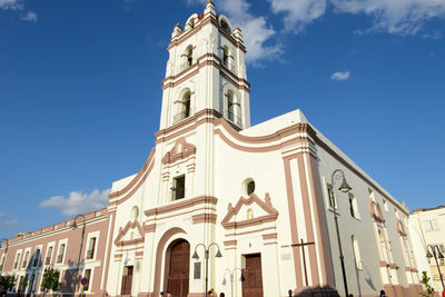 Low angle view of bell tower against blue sky