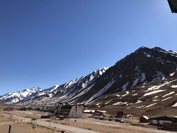 Scenic view of snowcapped mountains against clear blue sky