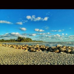 Scenic view of sea against cloudy sky