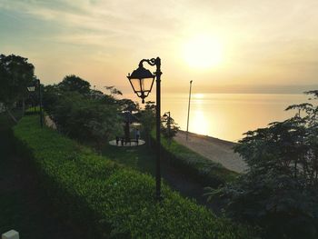 Scenic view of amusement park against sky during sunset