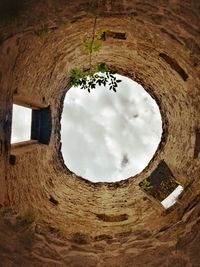 Directly below shot of old building against sky