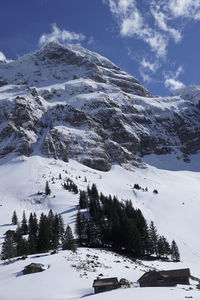 Scenic view of snow covered mountains against sky