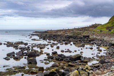 Rocks on beach against sky